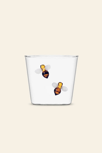 The Ichendorf Milano Garden Picnic Tumbler by Ichendorf Milano features two whimsical bees with yellow and black stripes and translucent wings, adding garden-inspired charm to its clear glass design.