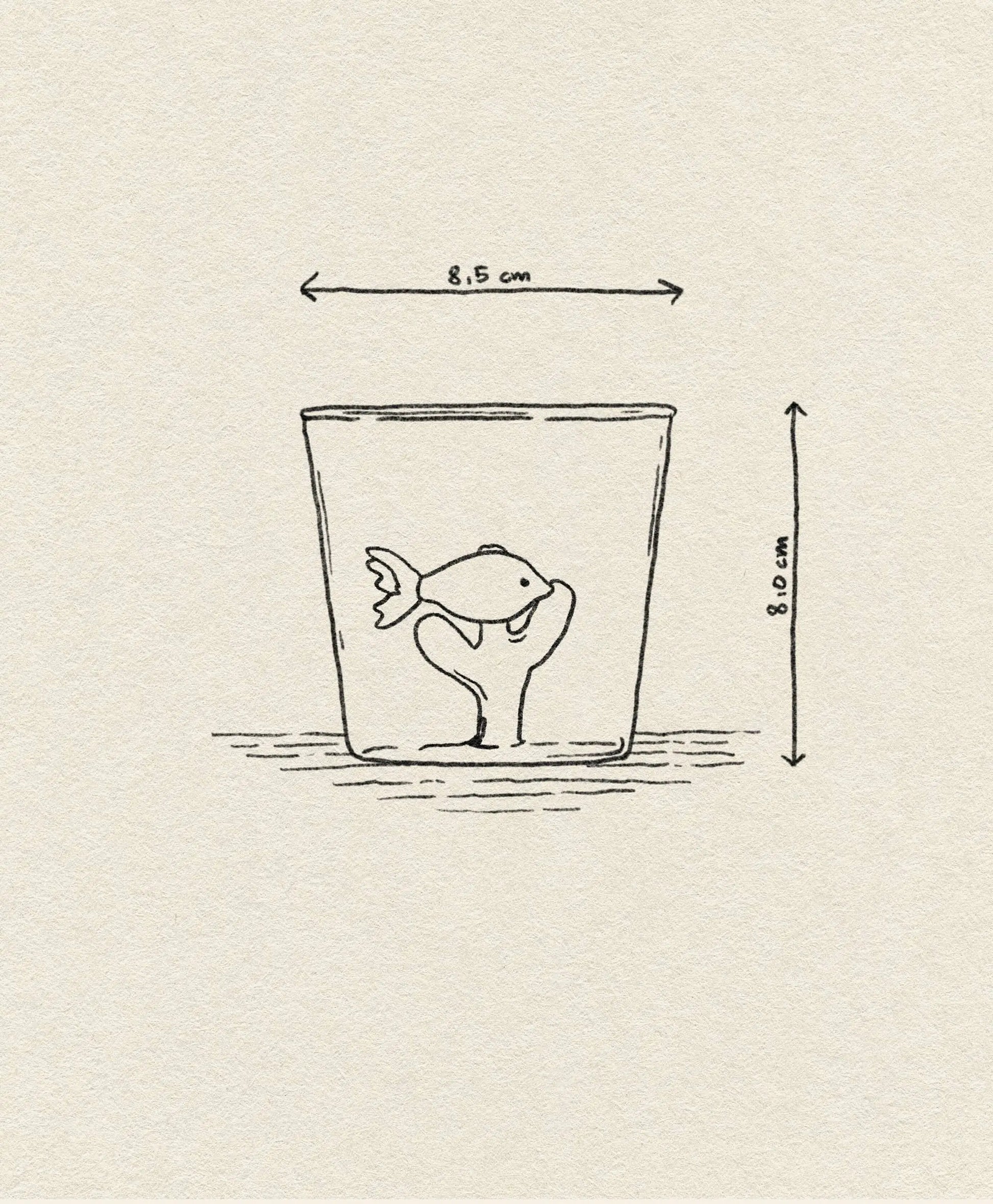 A simple sketch shows a fish in the Ichendorf Milano Marine Garden Tumbler, with hand-shaped water cupping the fish. The glass is 8.5 cm wide and 8.0 cm tall, set against a plain, lightly textured paper background.
