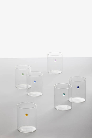 The Ichendorf Milano Soleils Tumbler Set of 6 features handcrafted glassware, each accented with a single colored dot—yellow, green, blue, purple, turquoise, and dark blue—displayed on a white surface against a plain light background.
