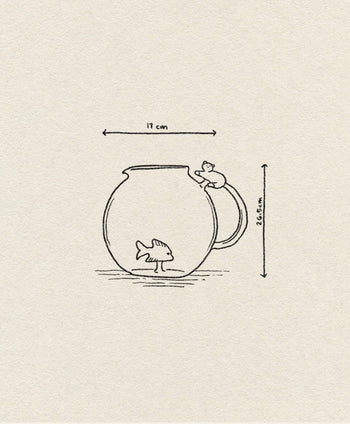 The Ichendorf Milano Tabby Cat Jug features a white cat with an amber tail perched on the handle, reaching for a pink fish inside the fishbowl-shaped jug. Dimensions: 17 cm wide, 26.5 cm high. Brand: Ichendorf Milano.