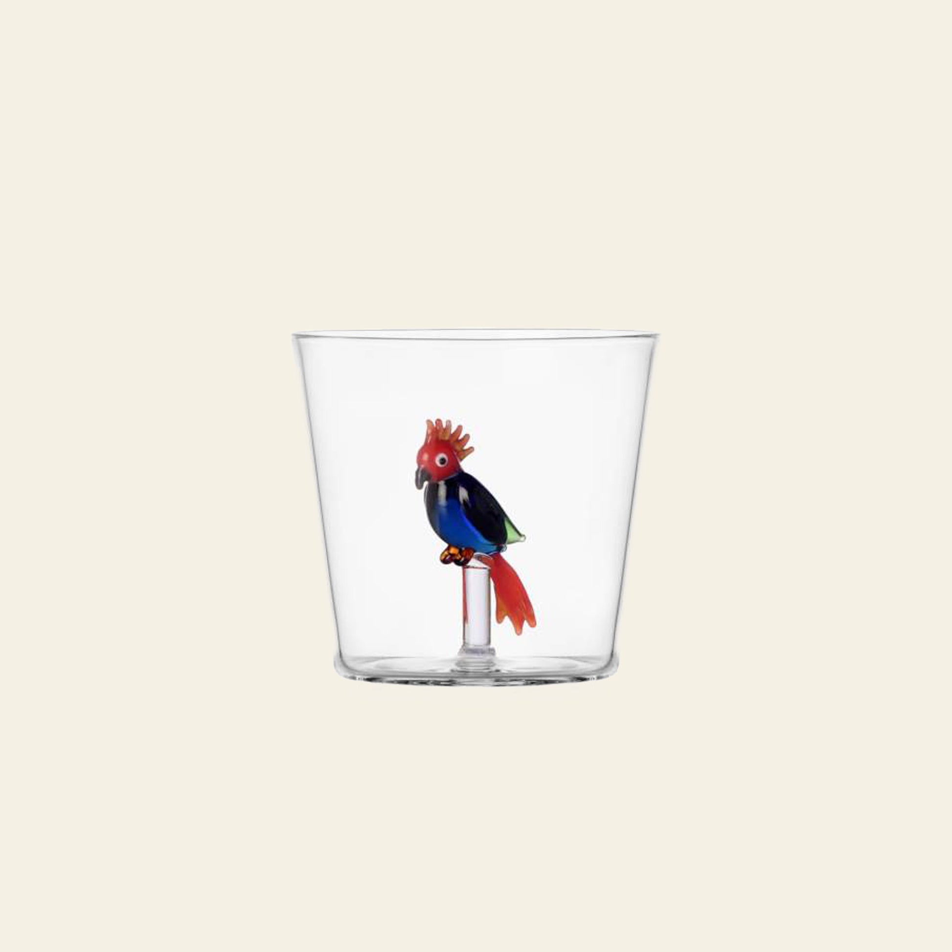 The Ichendorf Milano Talking Trees Tumbler features a handcrafted glass design with a red and blue cockatoo perched inside, adding a playful touch to your drinkware collection.