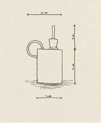 A minimalist line drawing of the Ichendorf Milano Tokio Balsamic Vinegar Bottle by Ichendorf Milano features labeled dimensions: 10 cm width (with handle), 12 cm height, 5 cm for the stopper, and a base width of 7 cm.
