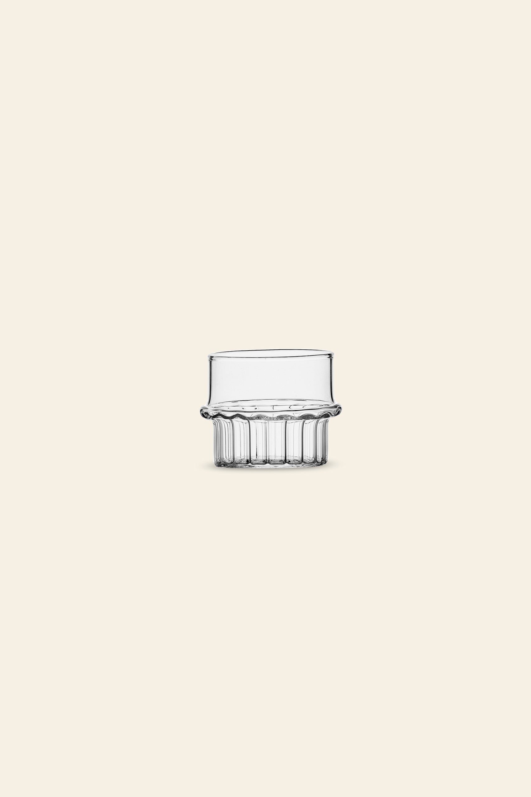 The Ichendorf Milano Transit Coffee Cup, with its wide rim and textured, fluted base, stands centered against a plain light beige background.