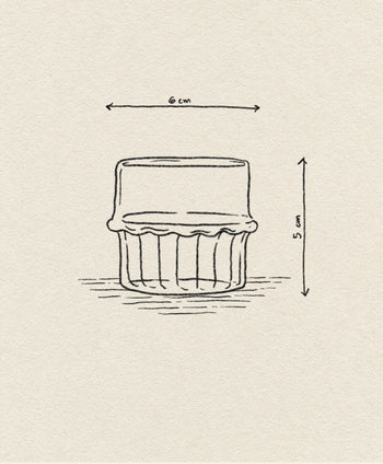 A hand-drawn sketch of the Ichendorf Milano Transit Coffee Cup by Ichendorf Milano, featuring ridged sides, labeled arrows showing its 6 cm width and 5 cm height, and highlighting its unique handcrafted design.