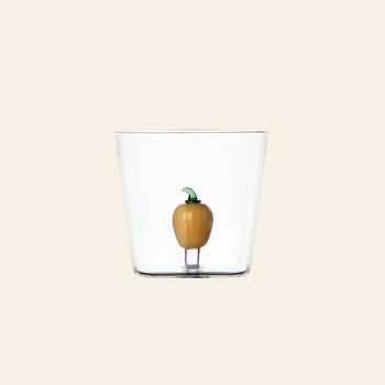 The Ichendorf Milano Vegetables Tumbler by Ichendorf Milano features a small yellow pepper figurine at its base—a unique handcrafted glass cup from the Vegetables collection, shown here on a plain beige background.