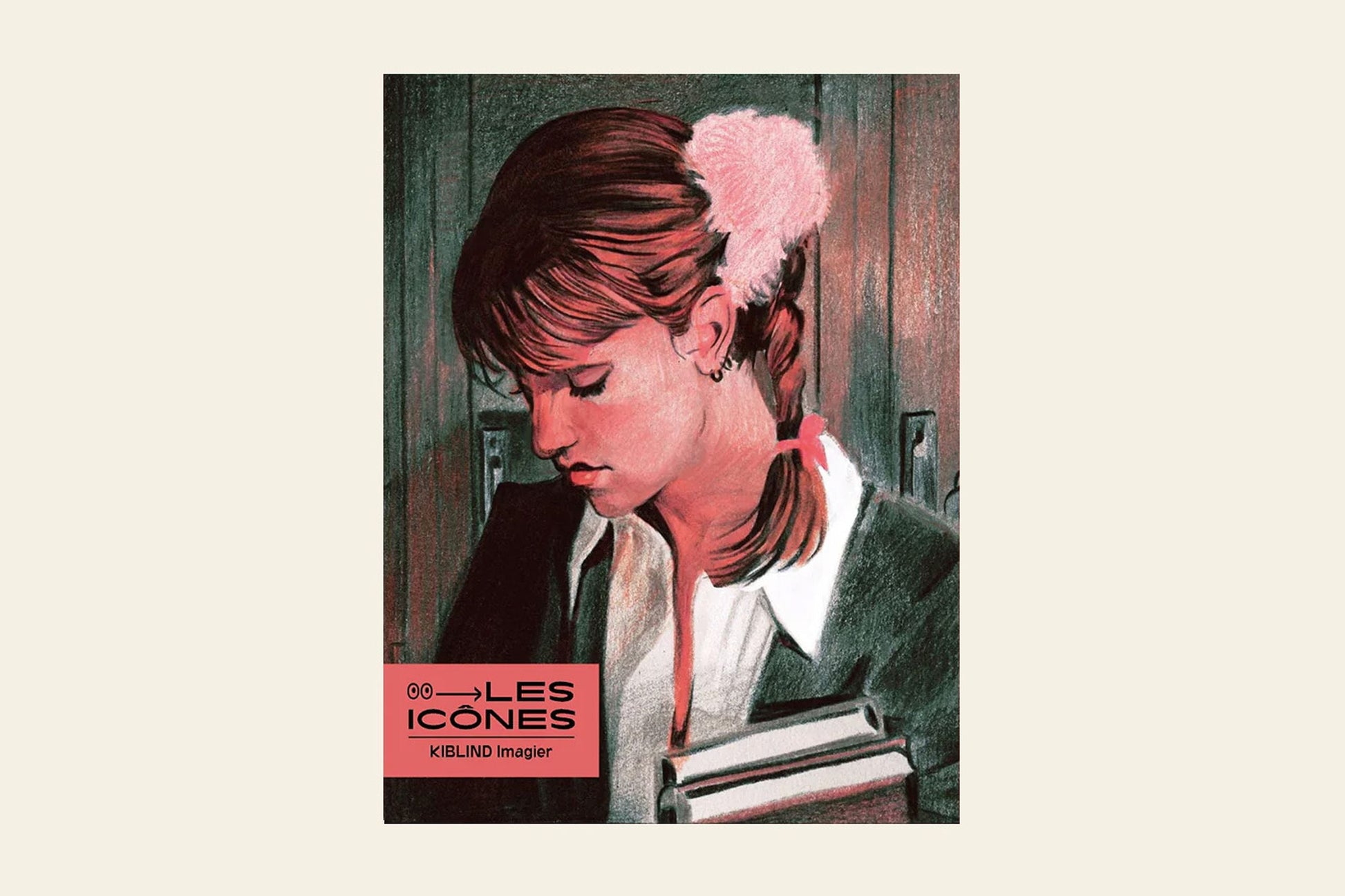 A young woman with brown pigtails and a pink hair accessory looks down, holding books. Against muted pink and green, the KIBLIND Atelier Picture Book - Icons by KIBLIND Atelier evokes a modern collection of legendary figures.