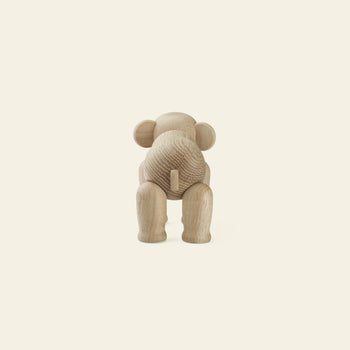 A wooden elephant figurine viewed from behind, displaying its rounded head, back, and tail with legs slightly apart—an iconic example of Danish design from Kay Bojesen—set against a plain, light background. Product: Kay Bojesen Elephant Mini.