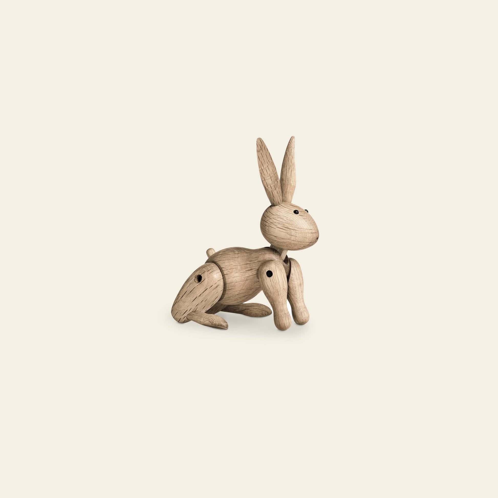 The Kay Bojesen Rabbit Mini by Kay Bojesen is a small, light brown wooden figurine with jointed limbs and upright ears, inspired by Danish craftsmanship—an enchanting take on whimsical wooden toys.