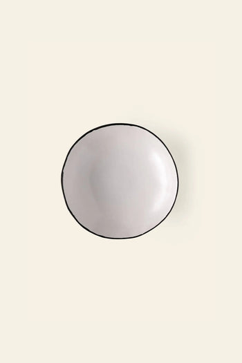The Kra Sanctuary Andaman Free-Form Dinner Plate features a classic white glaze and timeless design, inspired by island living. Seen from above on a light beige background, it embodies the effortless elegance of Kra Sanctuary diningware.