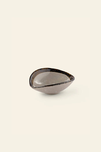 The Kra Sanctuary Satay Shell Dipping Dish by Kra Sanctuary is a small, asymmetrical ceramic bowl featuring a glossy gray and brown mottled finish with an iridescent border—an ideal addition to your earthy dinnerware collection.