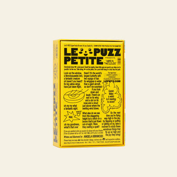 The Le Puzz Head in the Clouds, 81 Piece Puzzle comes in a bright yellow box with playful black text, hand-drawn illustrations, and whimsical doodles—inviting imagination against a plain, light background.