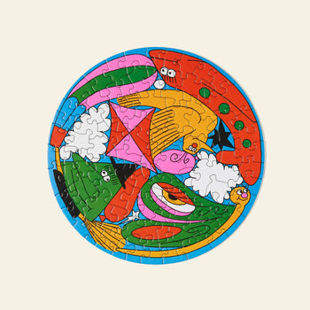 The Le Puzz Head in the Clouds 81 Piece Puzzle by Le Puzz features a completed circular design with whimsical animal shapes, geometric patterns, and bright colors that spark imagination against a light background.