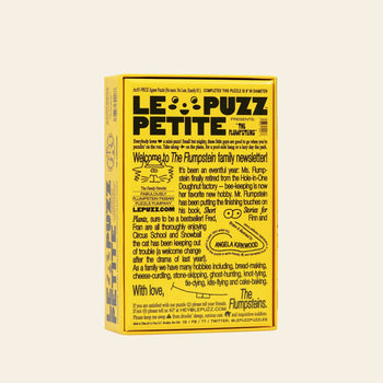 A yellow Le Puzz The Flumpsteins 81-piece puzzle box with playful black text, cheerful face illustrations, and a quirky newsletter-style design from The Flumpsteins family, sharing updates and Snowball the cat’s adventures.