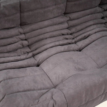 Close-up of the Ligne Roset Togo Corner Seat by Ligne Roset, featuring plush grey ruched upholstery and soft, comfortable cushions that highlight its modular design and detailed texture.