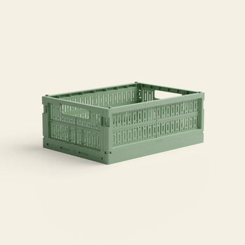 The Made Crate Midi by Made Crate is a light green, rectangular recycled plastic storage crate with side handles and a ventilated slatted design for easy stacking, shown against a plain off-white background.