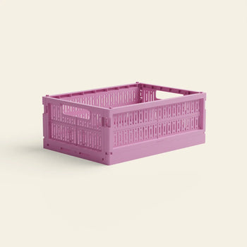 The Made Crate Midi by Made Crate is a pink recycled plastic storage crate with open slats and handles for easy stacking, shown against a plain light background.