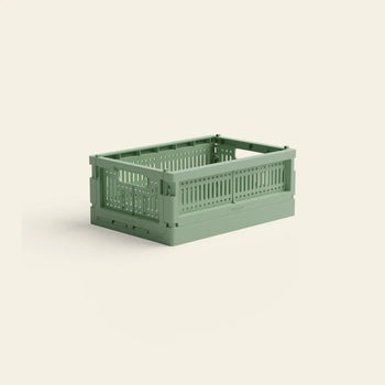The Made Crate Mini by Made Crate is a green, stackable storage crate made from recycled plastic with ventilation holes, shown on a plain light background, offering convenient organization.