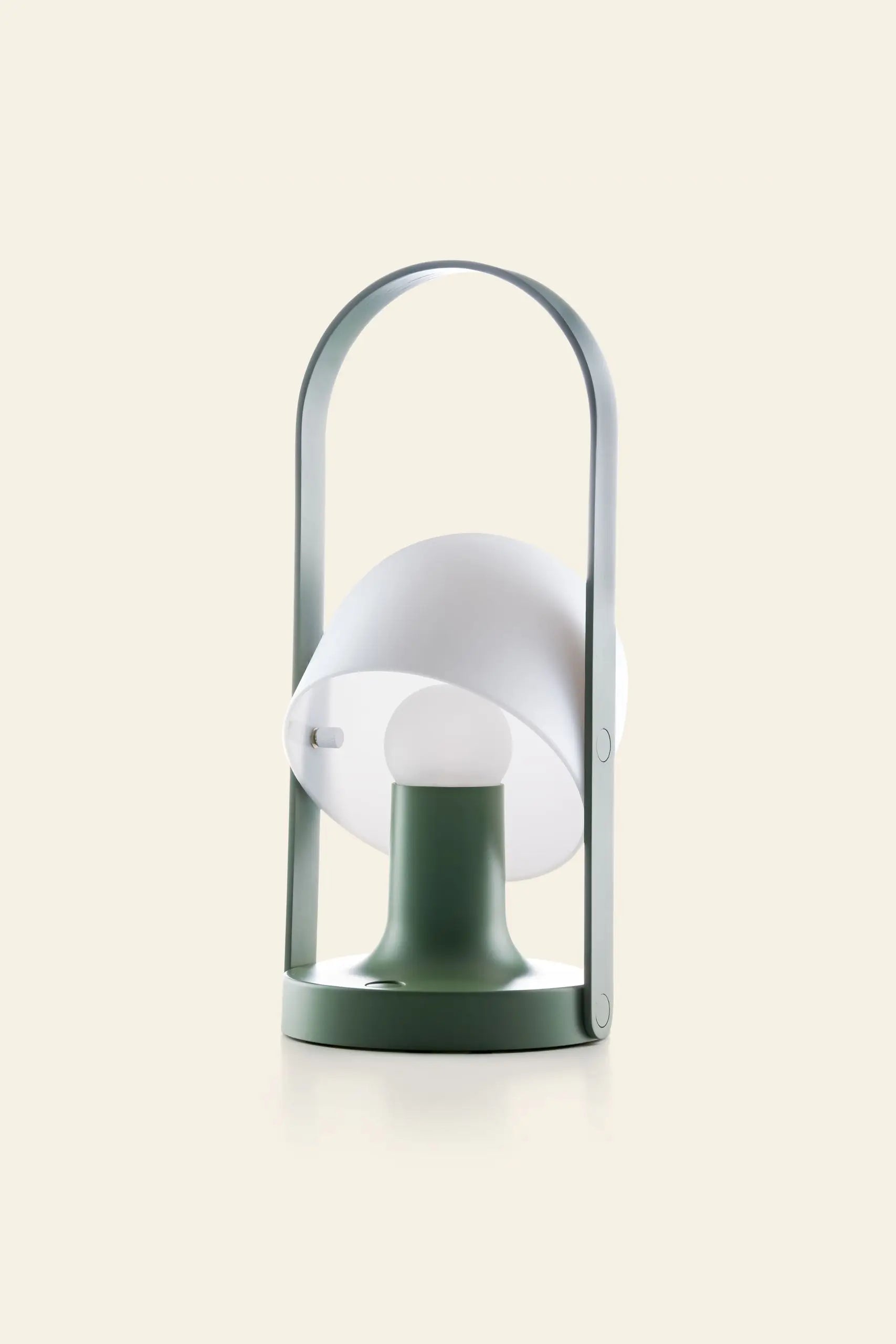 The Marset FollowMe Portable Table Lamp by Marset features a green base, cylindrical stem, tiltable white lampshade, and an arched oak handle—a stylish modern lamp displayed against a plain beige background.