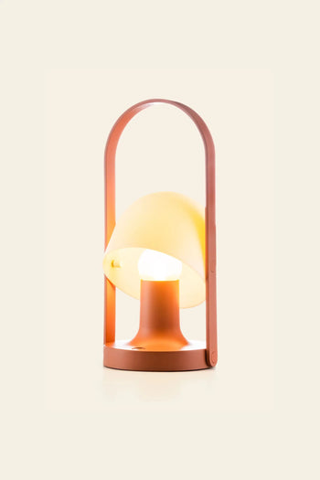 The Marset FollowMe Portable Table Lamp by Marset features a brown frame, oak handle, yellow dome-shaped shade, and circular base, displayed against a plain beige background.
