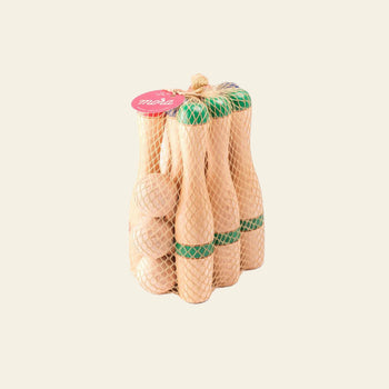 The Mora Play Bowling Pins 24cm, Set of 6 by Mora Play includes six wooden pins and two green-striped balls in a yellow fabric bag with a red tag, shown against a beige background.