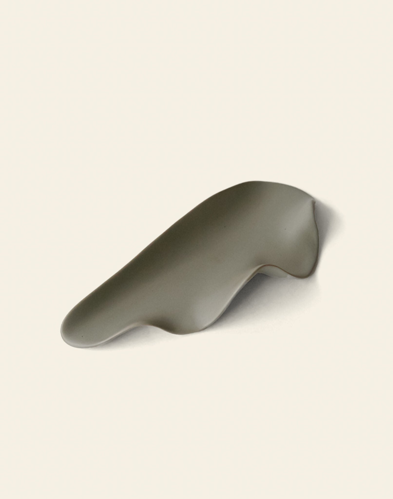 The NR Ceramics HIN Leaf Plate is a smooth gray ceramic dish with gentle curves, offering multi-functional tableware from NR Ceramics, elegantly displayed on a light off-white background.