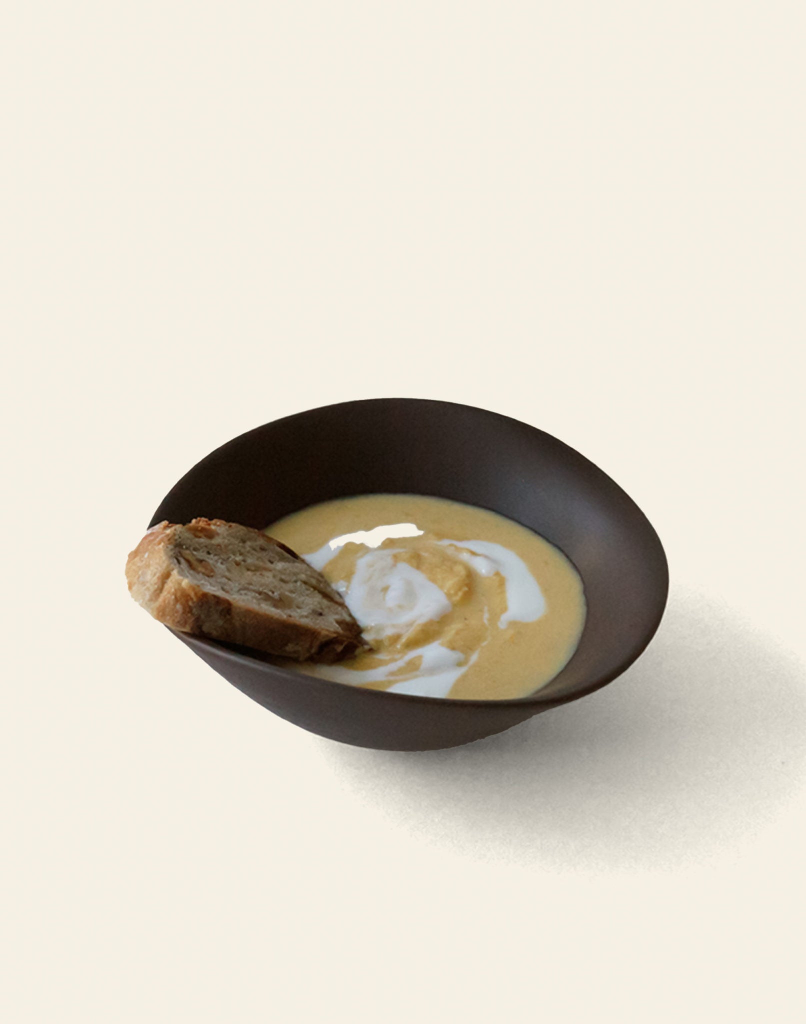 The NR Ceramics HIN Soup Bowl by NR Ceramics, filled with creamy soup and rustic bread on the side, sits against a plain background—versatile tableware perfect for any dining setting.