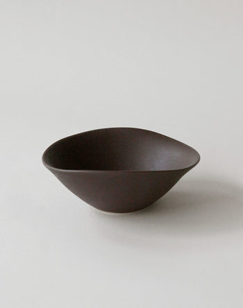 The NR Ceramics HIN Soup Bowl by NR Ceramics features smooth, curved edges and a dark brown finish, making it versatile tableware suited to any setting. Shown here on a plain light background.