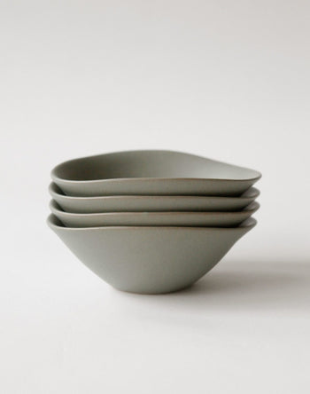 A stack of four NR Ceramics HIN Soup Bowls, featuring minimalist matte grey ceramic and smooth, subtly irregular edges, shown on a plain white background—stylish and versatile tableware by NR Ceramics for everyday meals.