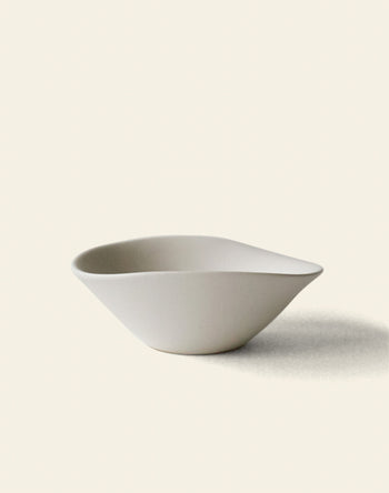 The NR Ceramics HIN Soup Bowl is a minimalist, matte white ceramic bowl with an organic, asymmetrical shape—an elegant and versatile piece from NR Ceramics, perfect for any table setting. Shown on a light background with a soft right-side shadow.