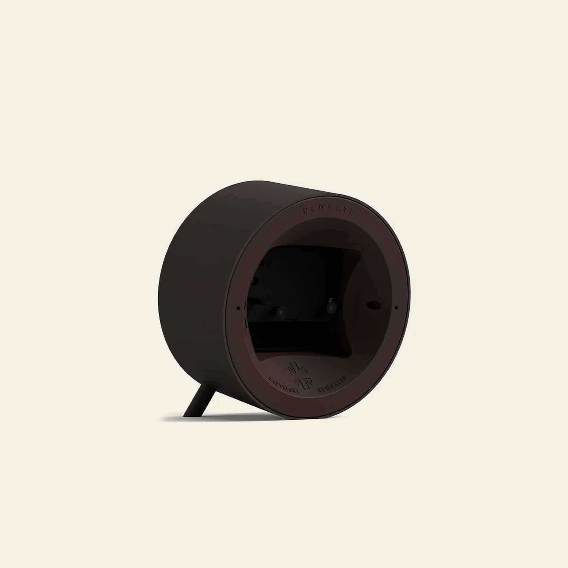The Newgate Fred Alarm Clock by Newgate features a dark brown, round, mid-century modern casing with two small legs—ideal for your bedside table. Its back panel houses the battery compartment and product details on a beige background.