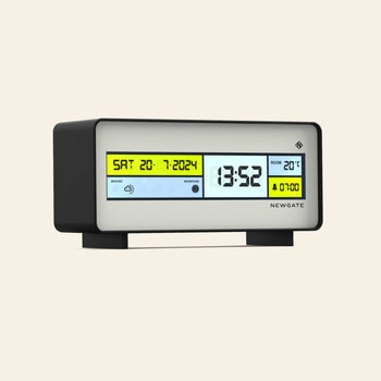 The Newgate Futurama LCD Alarm Clock by Newgate features a black and white rectangular design, showing the date, time, room temperature, and alarm on a yellow and white LCD screen with a clear temperature display.