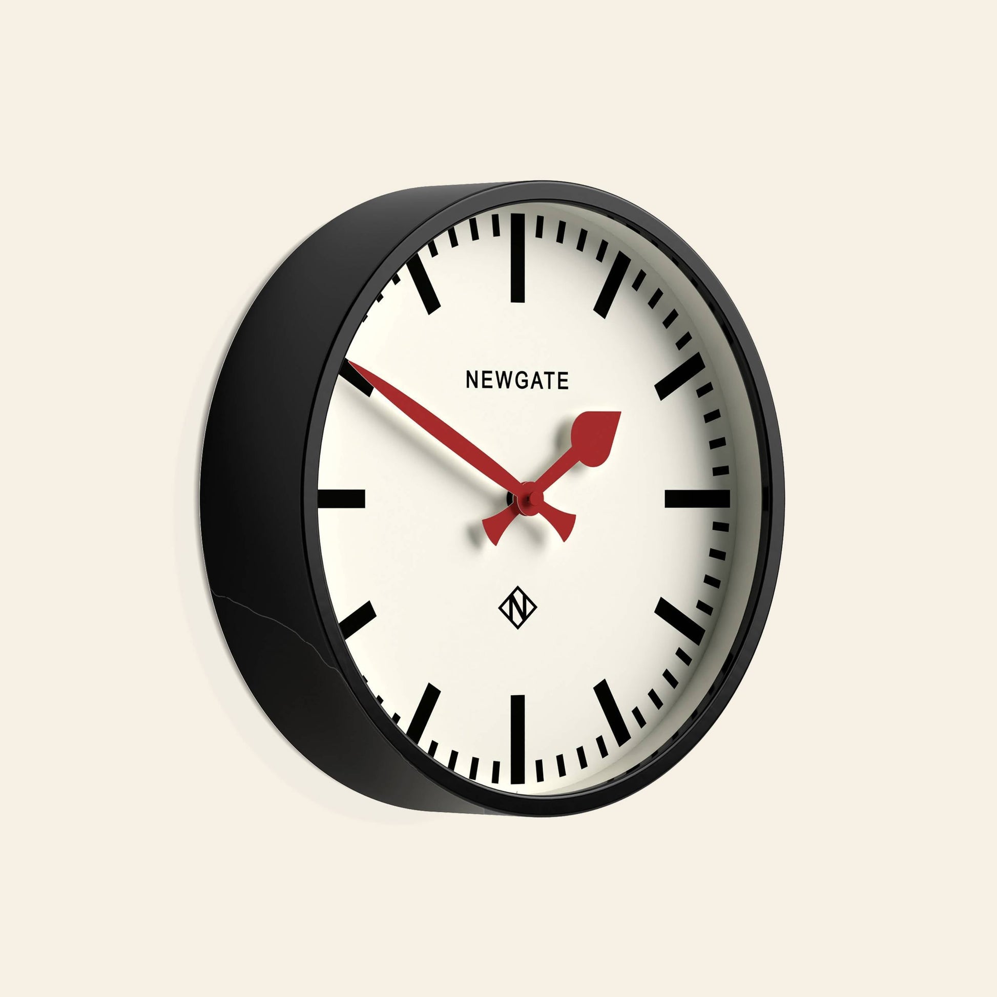 The Newgate Luggage Wall Clock features a black frame, white face, bold black hour markers, and a red second hand. This station-style wall clock by Newgate adds retro charm and stylish appeal to any room.
