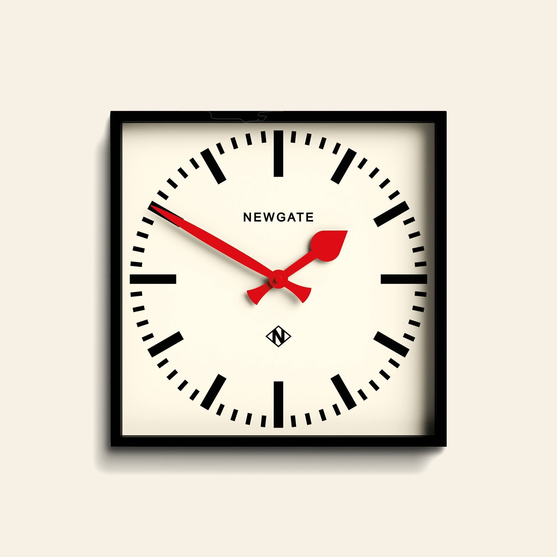 A minimalist black case frames the Newgate Number Five Railway Wall Clock, featuring a white face, bold black hour markers, vibrant red hands, and the Newgate logo at the top center. The time displayed is 10:08.