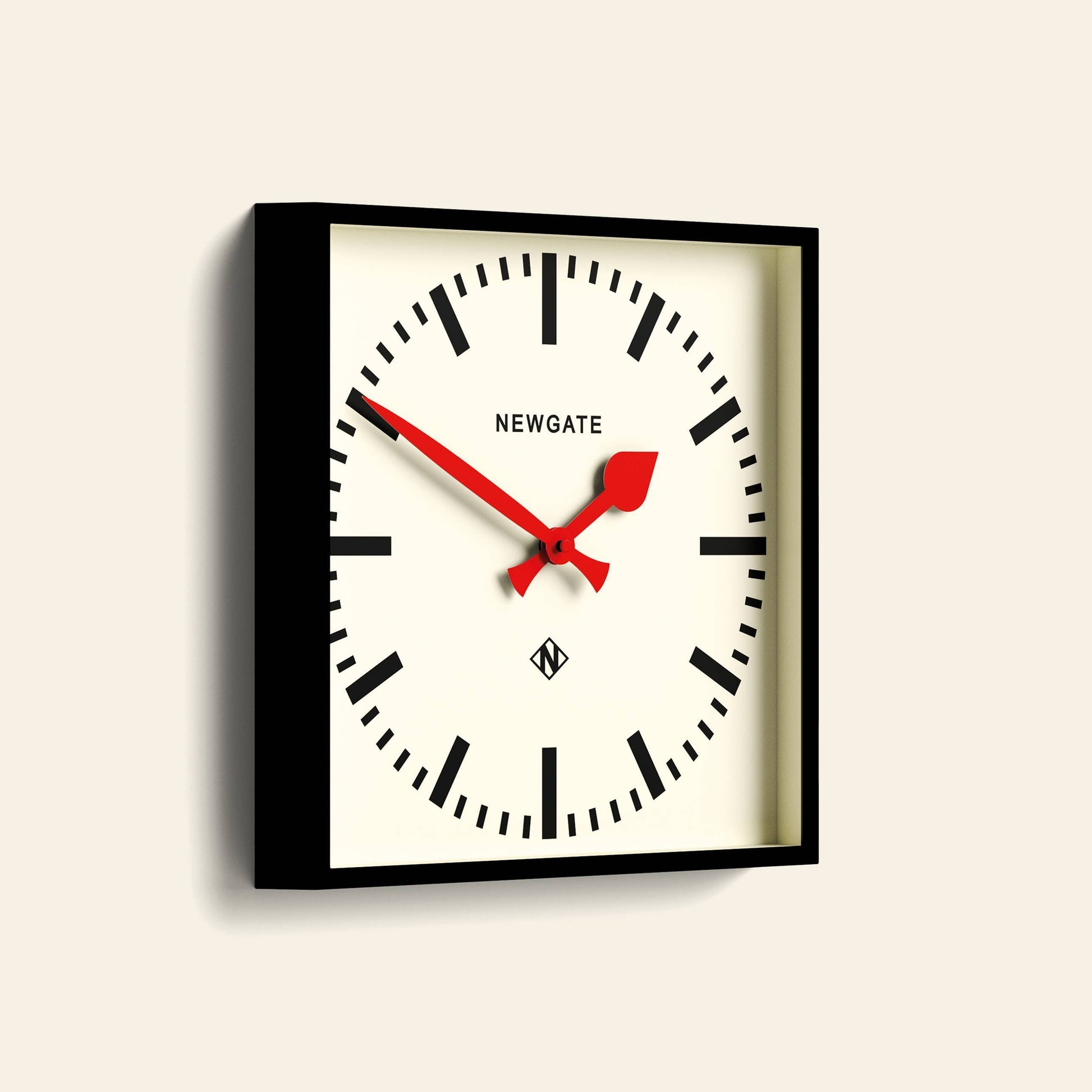 The Newgate Number Five Railway Wall Clock features a white face, black case, bold black markers, vibrant red hands, and the Newgate logo at the top center for classic-meets-modern style.