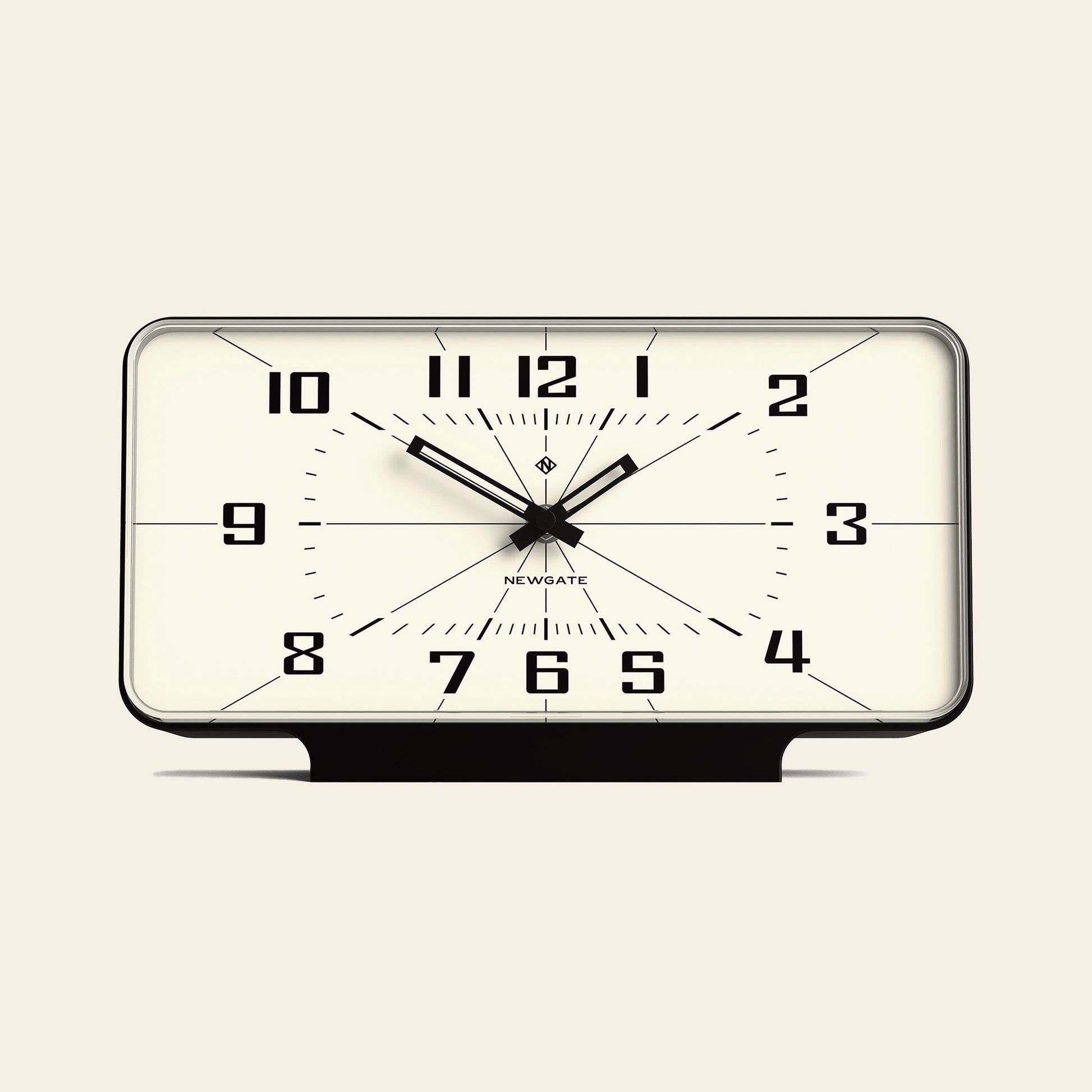 The Newgate Planet Mantel Clock features a rectangular black frame, bold Arabic numerals, and hands on a white face showing 10:10:31. The Newgate logo is below the center. It uses a silent sweep quartz movement for quiet operation.
