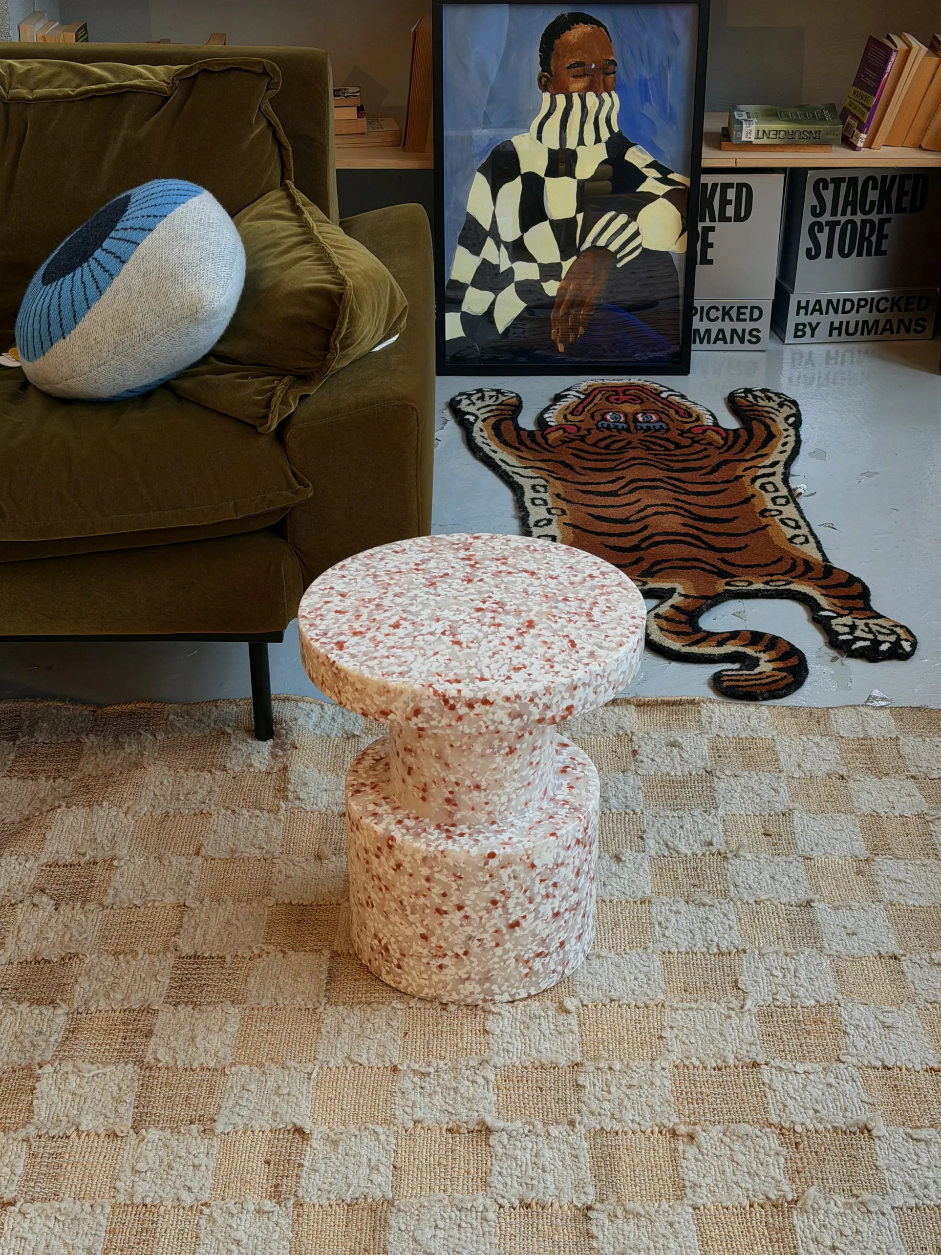 Close-up of a two-tiered cake with a textured white surface dotted with brown and tan bits, echoing the versatile design of the Normann Copenhagen Bit Stool by Normann Copenhagen.