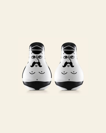 The Normann Copenhagen Friends Salt & Pepper Set features two white, egg-shaped figurines with cartoon faces, black mustaches, and swimsuits—a fun gift for fans of playful design by Normann Copenhagen.