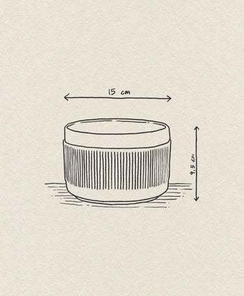 A hand-drawn illustration showcases the Normann Copenhagen Junto Bowl (15cm) with vertical grooves, highlighted by arrows and measurements, set against a textured background for your dinner table.