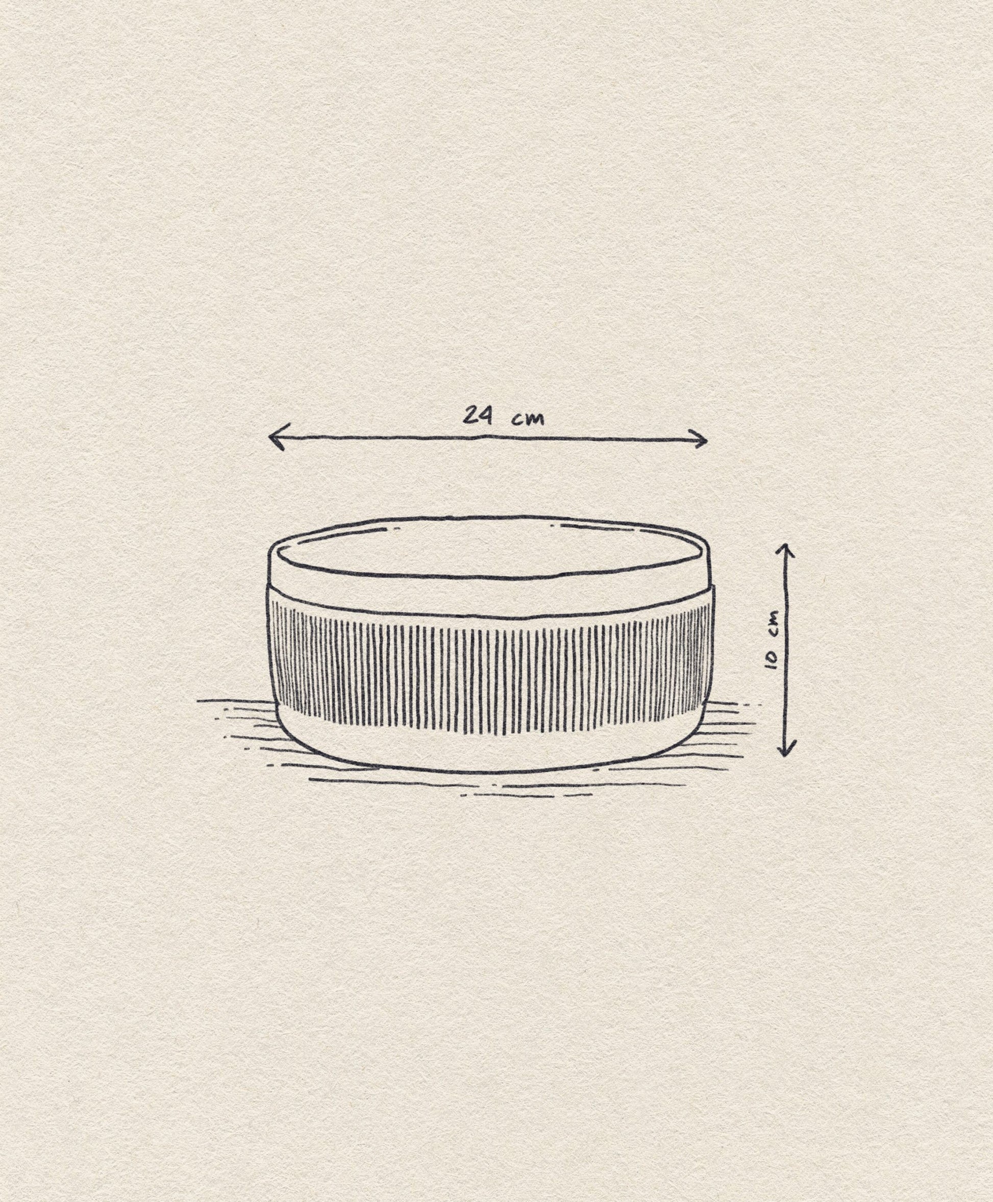 The Normann Copenhagen Junto Bowl, 24cm, features hand-drawn vertical lines and a rustic terracotta finish. Arrows highlight its dimensions: 24 cm diameter and 10 cm height.