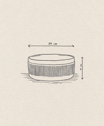 The Normann Copenhagen Junto Bowl, 24cm, features hand-drawn vertical lines and a rustic terracotta finish. Arrows highlight its dimensions: 24 cm diameter and 10 cm height.