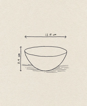 A simple line drawing of the Normann Copenhagen Krenit Bowl, 12.5cm, with dimensions (12.5 cm wide, 5.9 cm tall) labeled on a textured, off-white background—an understated tribute to classic Danish design from Normann Copenhagen.