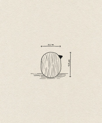 The Normann Copenhagen Little Bird (4.5 cm) is a small, round wooden bird with a short pointed tip, set against an off-white background—an ideal minimalist accent or unique decor piece from Normann Copenhagen.