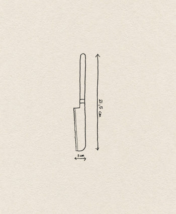 The Normann Copenhagen Pebble Cheese Knife features a 3 cm wide blade and is 21.5 cm long. Displayed on a plain off-white background, its subtle Scandinavian design highlights the craftsmanship of Normann Copenhagen.
