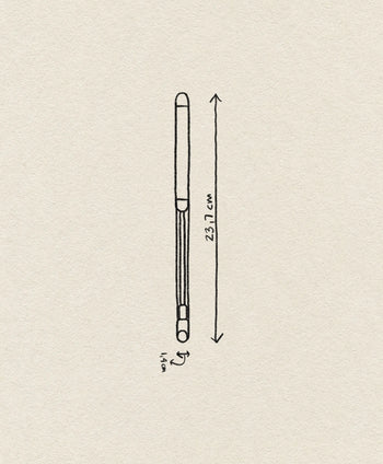 A minimalist line drawing of the Normann Copenhagen Pebble Cheese Slicer (23.7 cm x 1.6 cm) by Normann Copenhagen, displayed on a textured beige background.