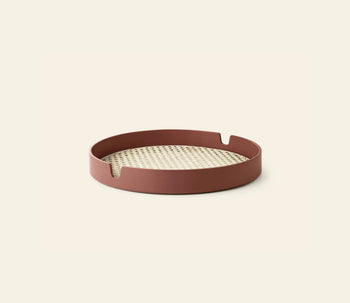 The Normann Copenhagen Salon Tray, 35cm, features a woven bamboo center and reddish-brown rim with two notched handles on opposite sides, shown against a plain light background.