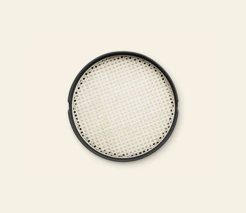 The Normann Copenhagen Salon Tray, 40cm, features a round black frame and woven cream mesh center, resembling a decorative serving piece by Normann Copenhagen, shown against a light beige background.