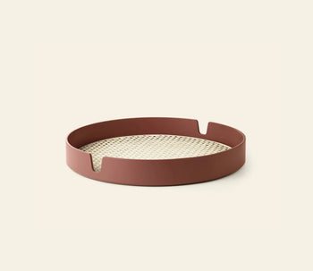 The Normann Copenhagen Salon Tray, 40cm, features a round bamboo design with a reddish-brown rim, notched details, and a woven beige base—a stylish serving piece for any setting.