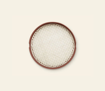 The Normann Copenhagen Salon Tray, 40cm, by Normann Copenhagen features a round design with a brown rim and woven white mesh surface, elegantly displayed on a light beige background.