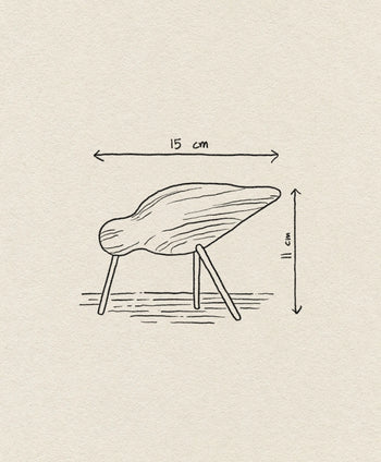 Minimalist line drawing of the Normann Copenhagen Shorebird Medium Oak, an abstract wooden sculpture with four legs. Labeled arrows show its dimensions: 15 cm long and 11 cm tall. Inspired by designs from Normann Copenhagen.