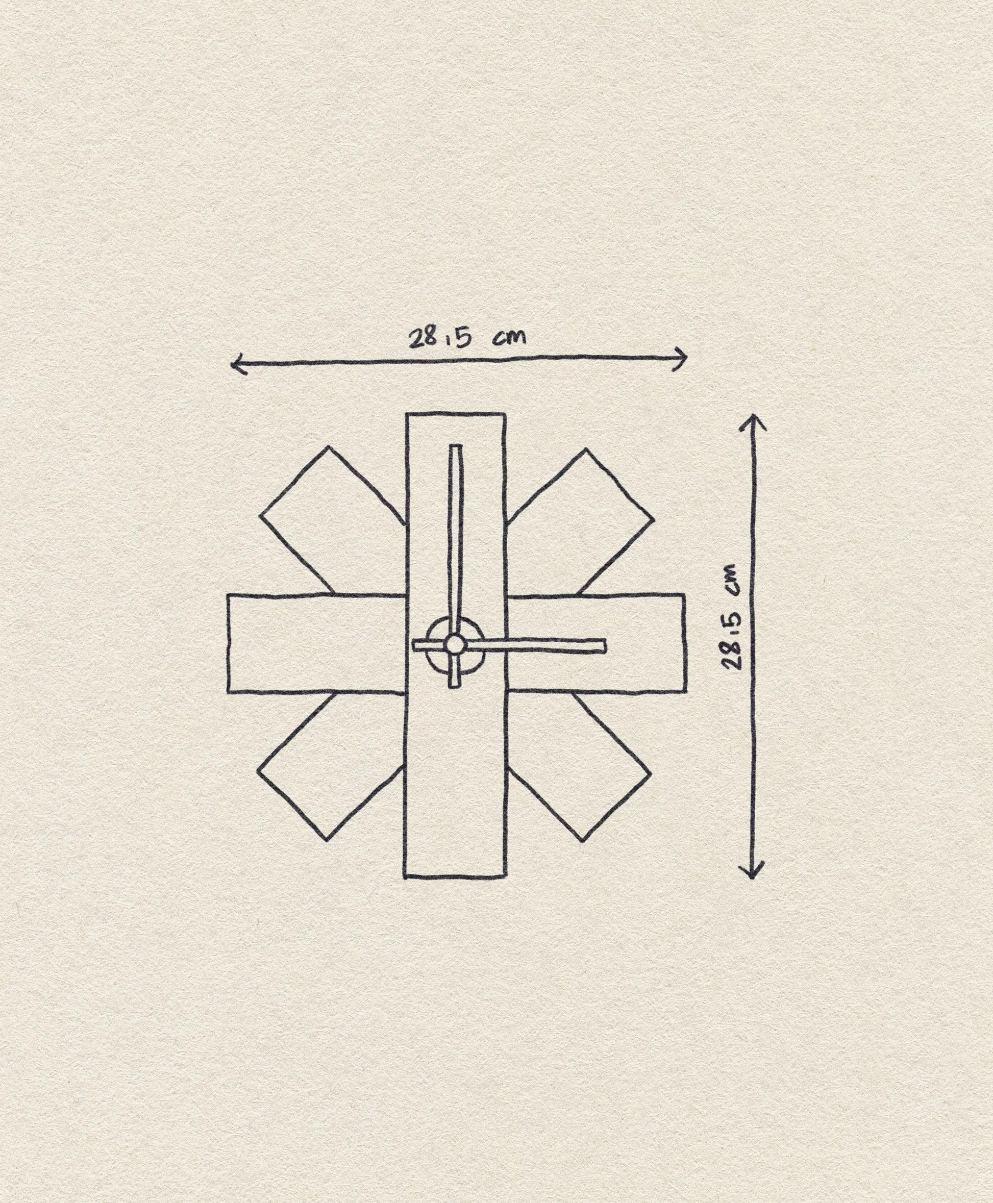 Hand-drawn diagram of the Normann Copenhagen Watch Me Wall Clock—a modern minimalist decor piece. Rectangular shapes radiate from the center, with width and height of 28.15 cm and clock hands pointing to 12:15. Brand: Normann Copenhagen.